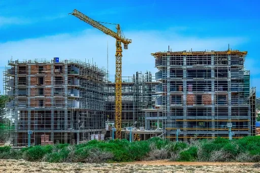 Large commercial building under construction with tower crane
